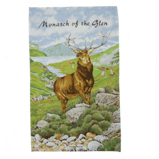 Tea towel with a stag design and 'Monarch of the Glen' text against a scenic background